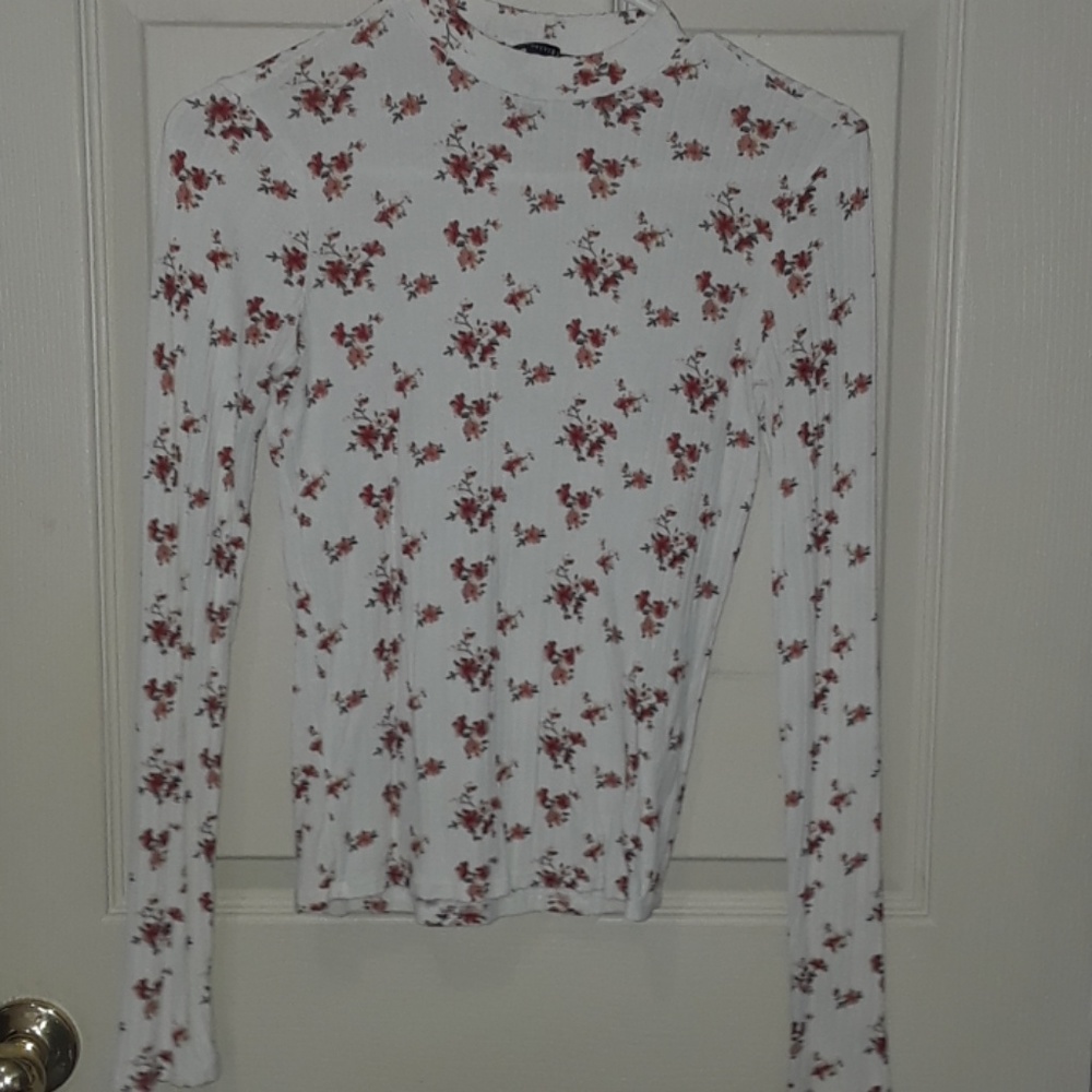 A pretty white long sleeve covered w/ flowers